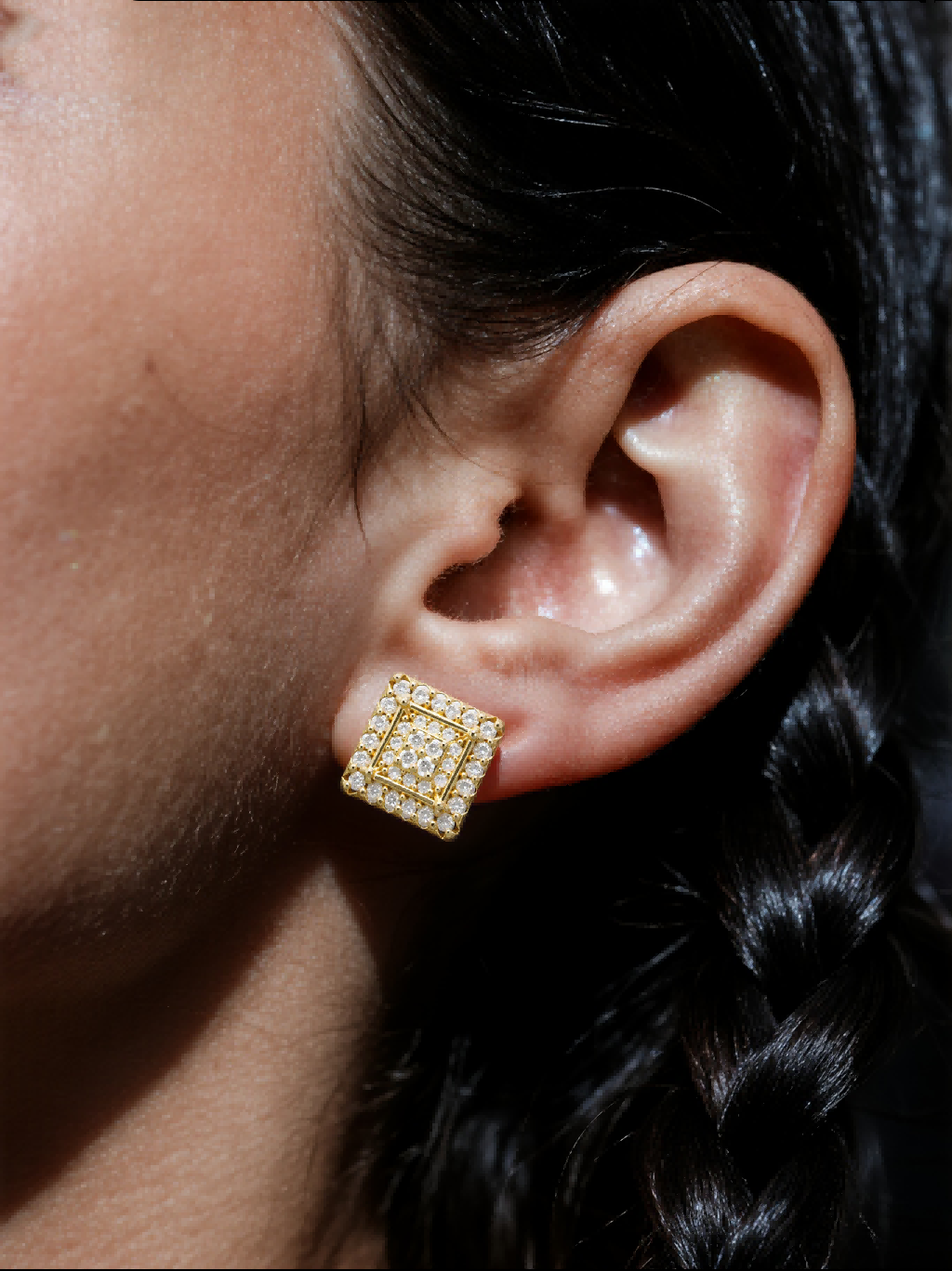 Own Your Bloom 14K gold diamond square flower earrings styled on woman in casual indoor lifestyle setting, Houston.