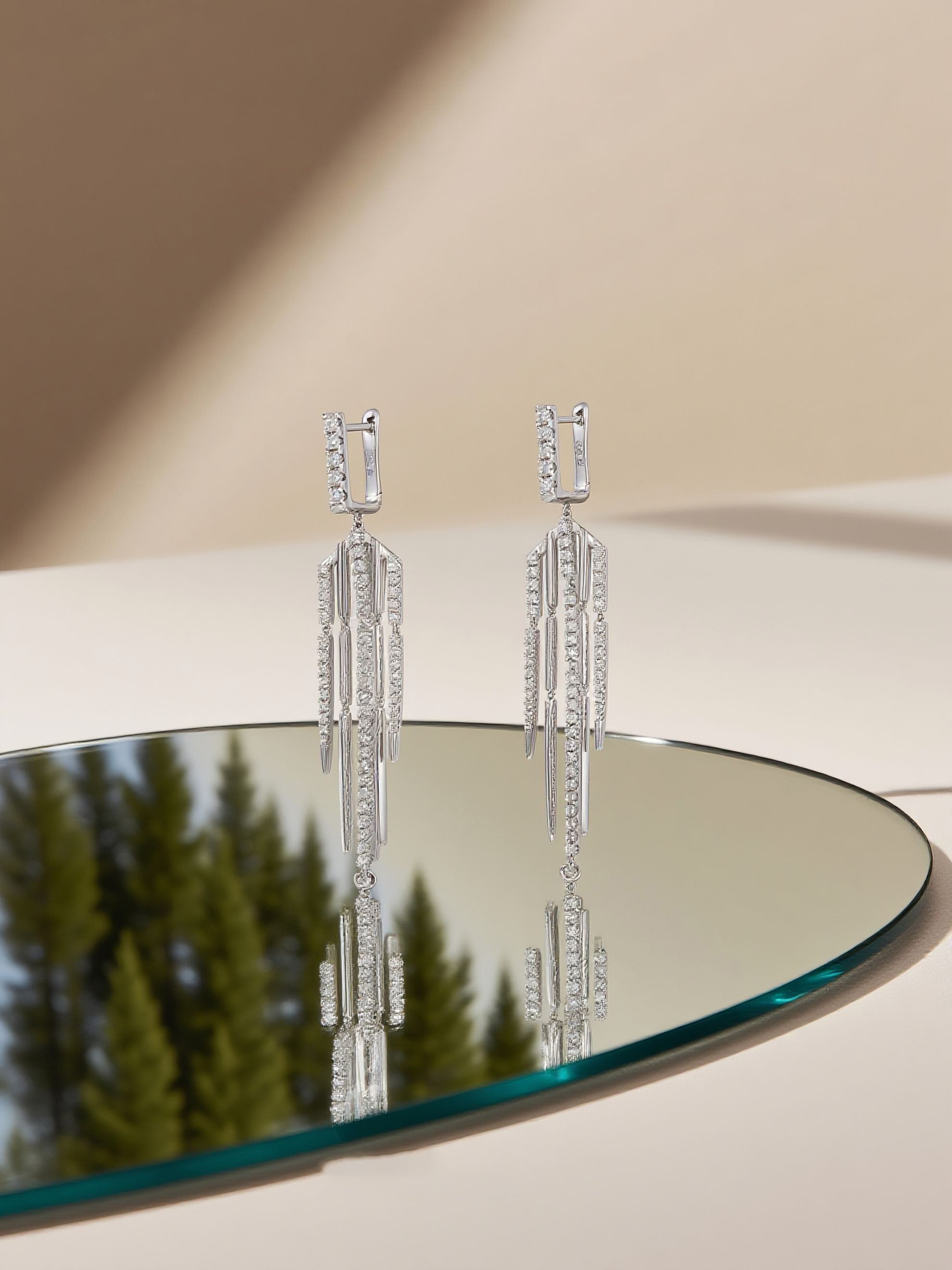 Own Your Bloom 14K white gold tassel diamond earrings in elegant studio setting with beige background and shadow play, Dallas.