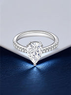 Own Your Bloom 14K teardrop diamond ring displayed on elegant navy surface with light reflection, luxury fine jewelry, Dallas.