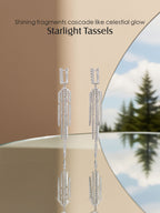 Own Your Bloom 14K tassel line diamond earrings displayed with reflection on mirror, celestial-inspired fine jewelry, Boston.