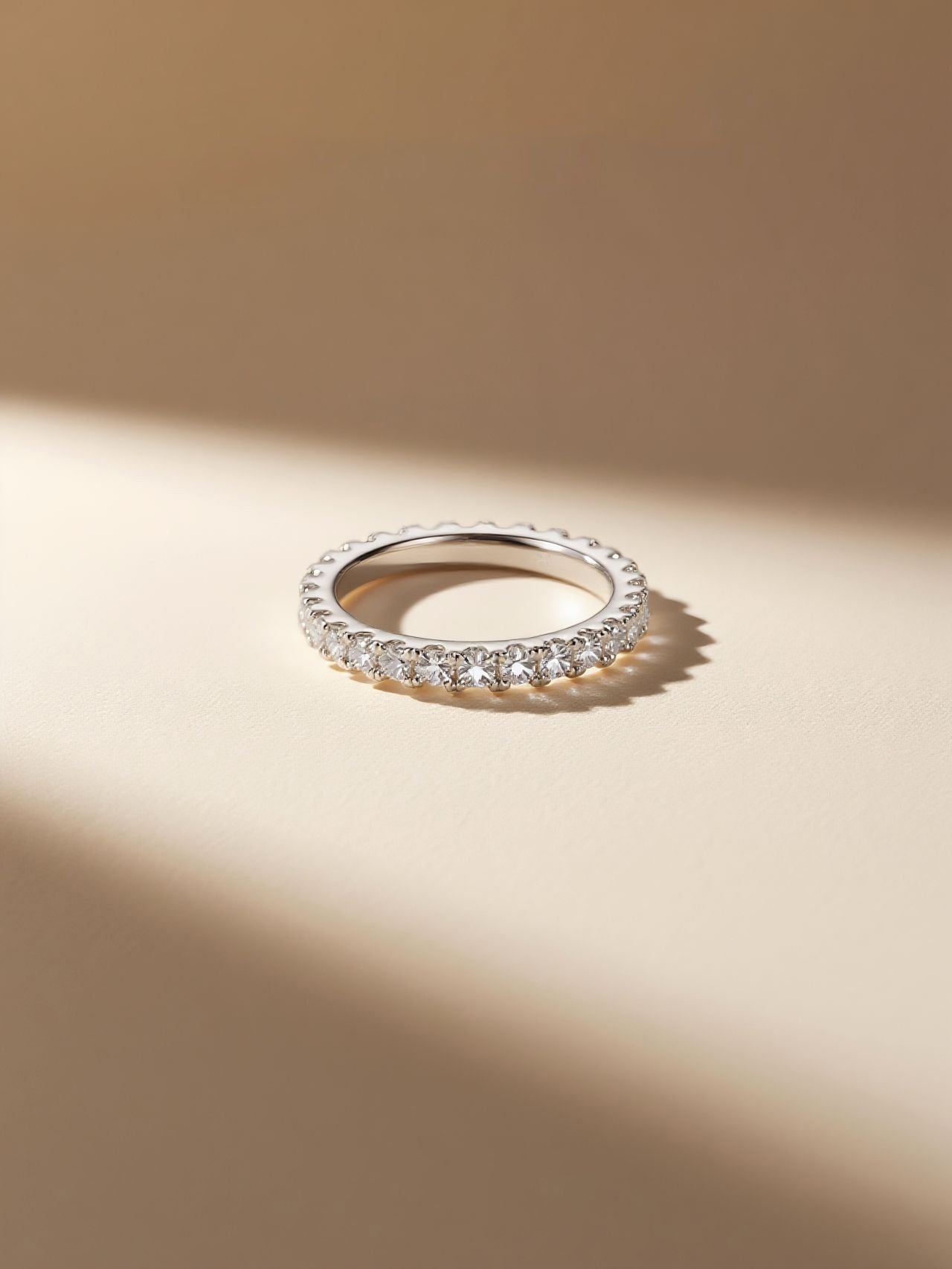 Own Your Bloom 14K white gold slim pavé diamond band, lifestyle product shot on glass with soft reflection, Los Angeles.