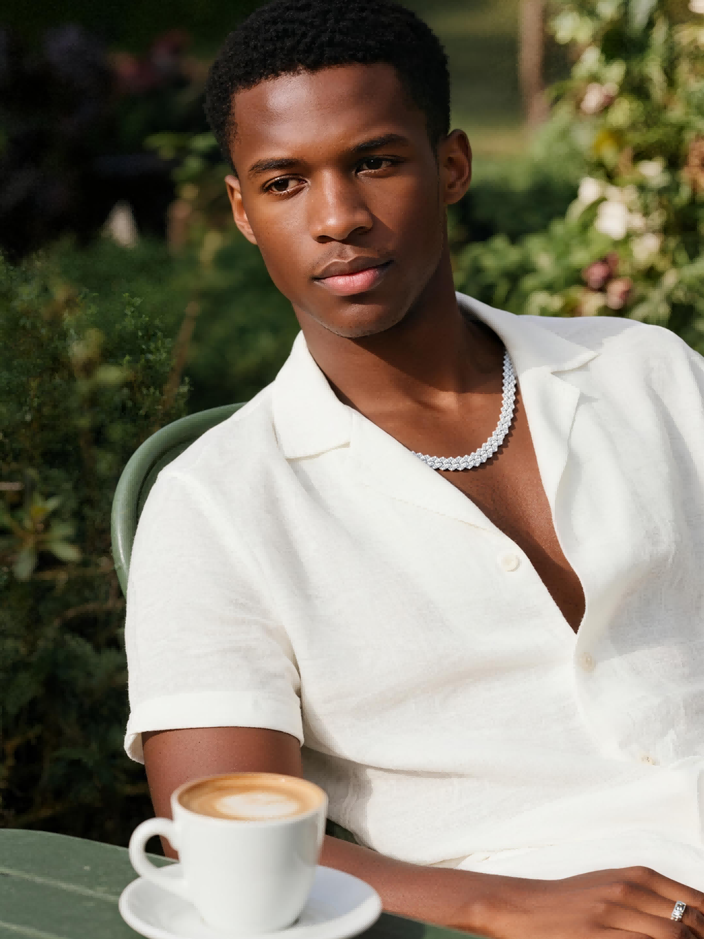 Own Your Bloom 14mm diamond Cuban link chain styled by man in nightlife setting, confident and fashionable, Los Angeles.