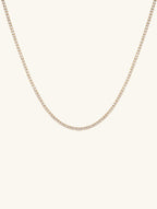 Own Your Bloom 4mm diamond 14K gold tennis chain, classic women’s jewelry product photo on white background, New York.