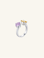 Own Your Bloom Colorful Gemstone Ring with radiant-cut citrine and cushion-cut amethyst on polished silver band, side view, Los Angeles.