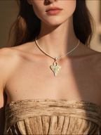 Own Your Bloom 14K diamond Ankh cross pendant worn by woman in natural daylight, Dallas.