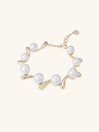 Close-up of Own Your Bloom Australian white shell pearl 14K diamond bracelet details on white background, New York jewelry.