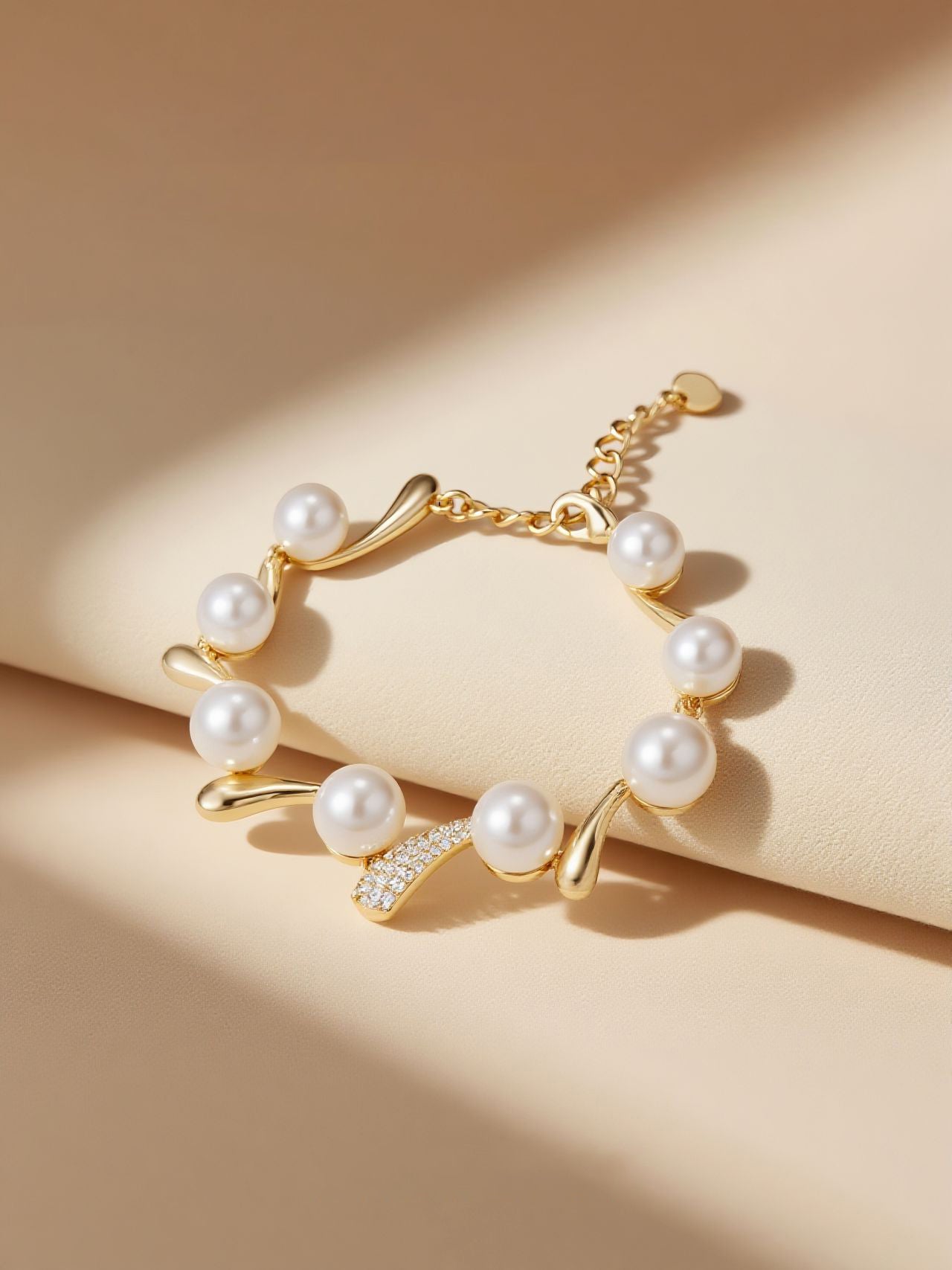 Lifestyle scene of Own Your Bloom Australian white shell pearl 14K diamond bracelet on fabric roll, New York studio light.