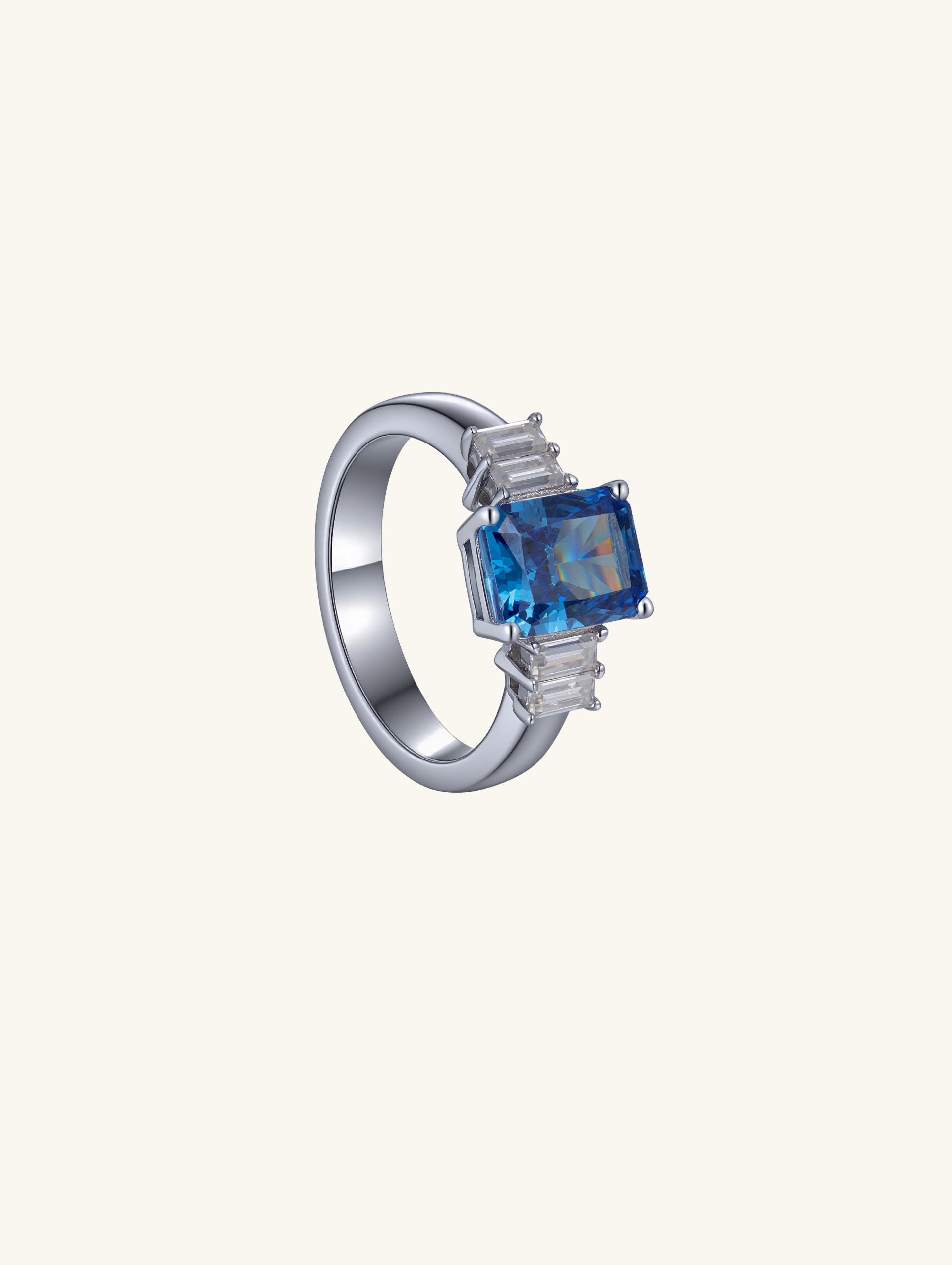 Own Your Bloom Blue Sapphire Baguette Diamond Ring side angle highlighting precision-cut gems and sleek silver band, Los Angeles.
