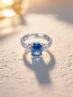 Own Your Bloom Emerald Cut Sapphire Ring captured in elegant studio setting, showcasing brilliance and timeless style, Dallas.