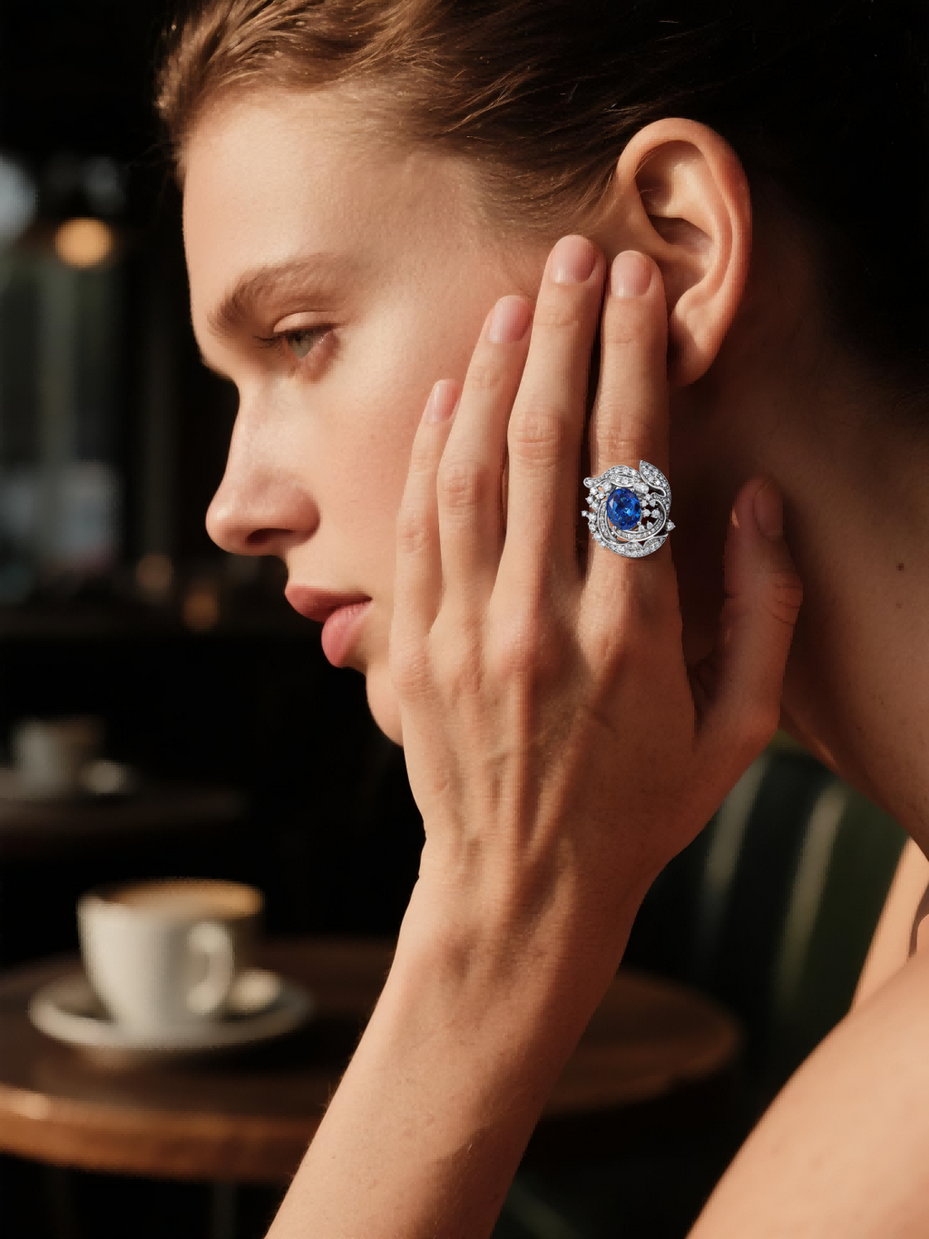 Own Your Bloom Blue Sapphire Diamond Halo Ring worn by woman in elegant black outfit, symbolizing refined beauty and strength, New York.