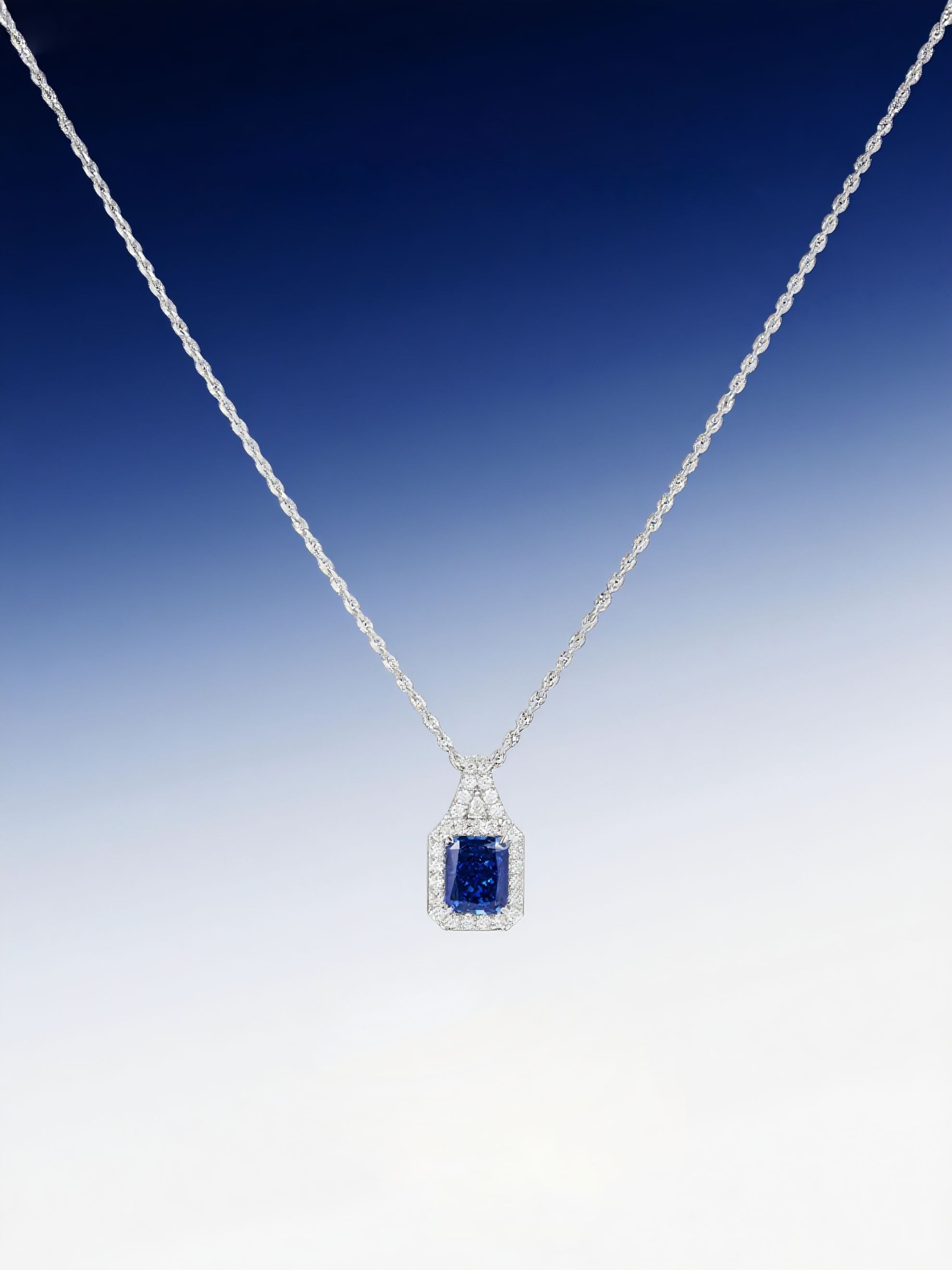 Own Your Bloom radiant blue sapphire halo pendant displayed against gradient blue background, symbolizing sophistication and luxury, Miami.
