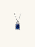 Own Your Bloom radiant blue sapphire pendant close-up highlighting gemstone brilliance and fine jewelry details, Chicago.
