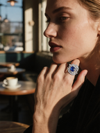 Own Your Bloom Blue Sapphire Diamond Halo Ring worn by woman showing radiant blue gemstone elegance and confidence, Miami.