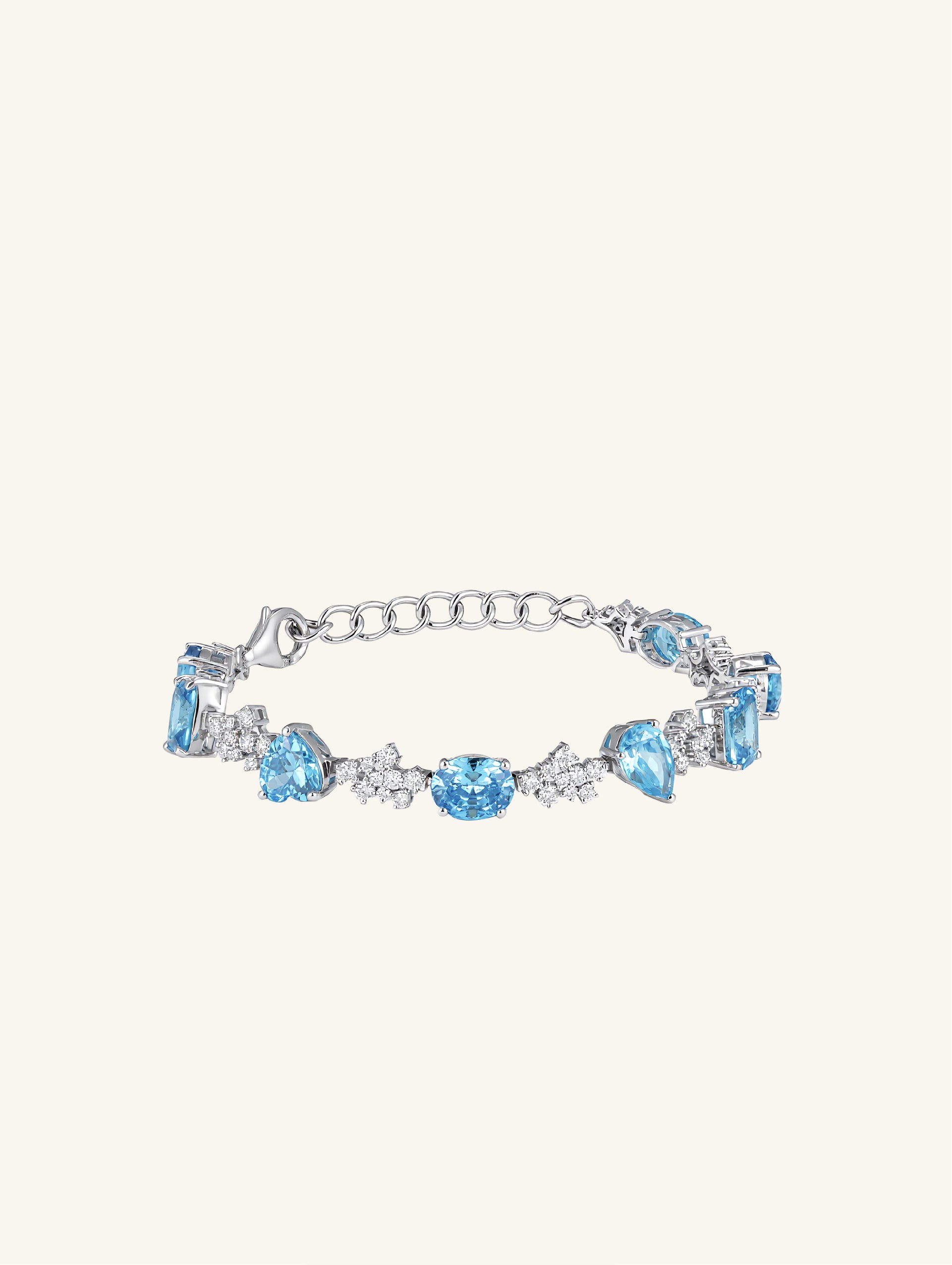 Own Your Bloom blue sapphire tennis bracelet front view featuring oval and baguette-cut stones in white gold, New York.