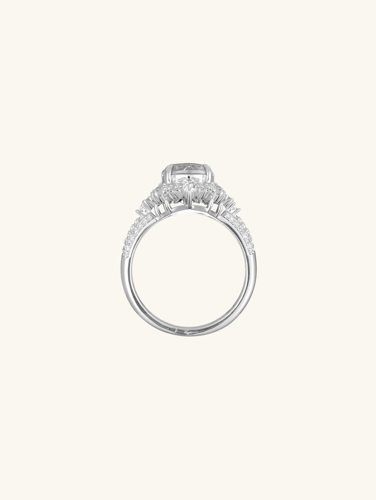 Angled view showing round center stone and pavé cluster halo on a polished band.