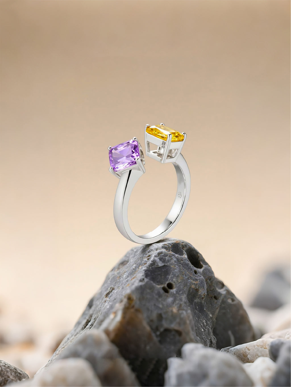 Own Your Bloom Colorful Gemstone Ring displayed on sand and rocks, representing color contrast and balance, Dallas.