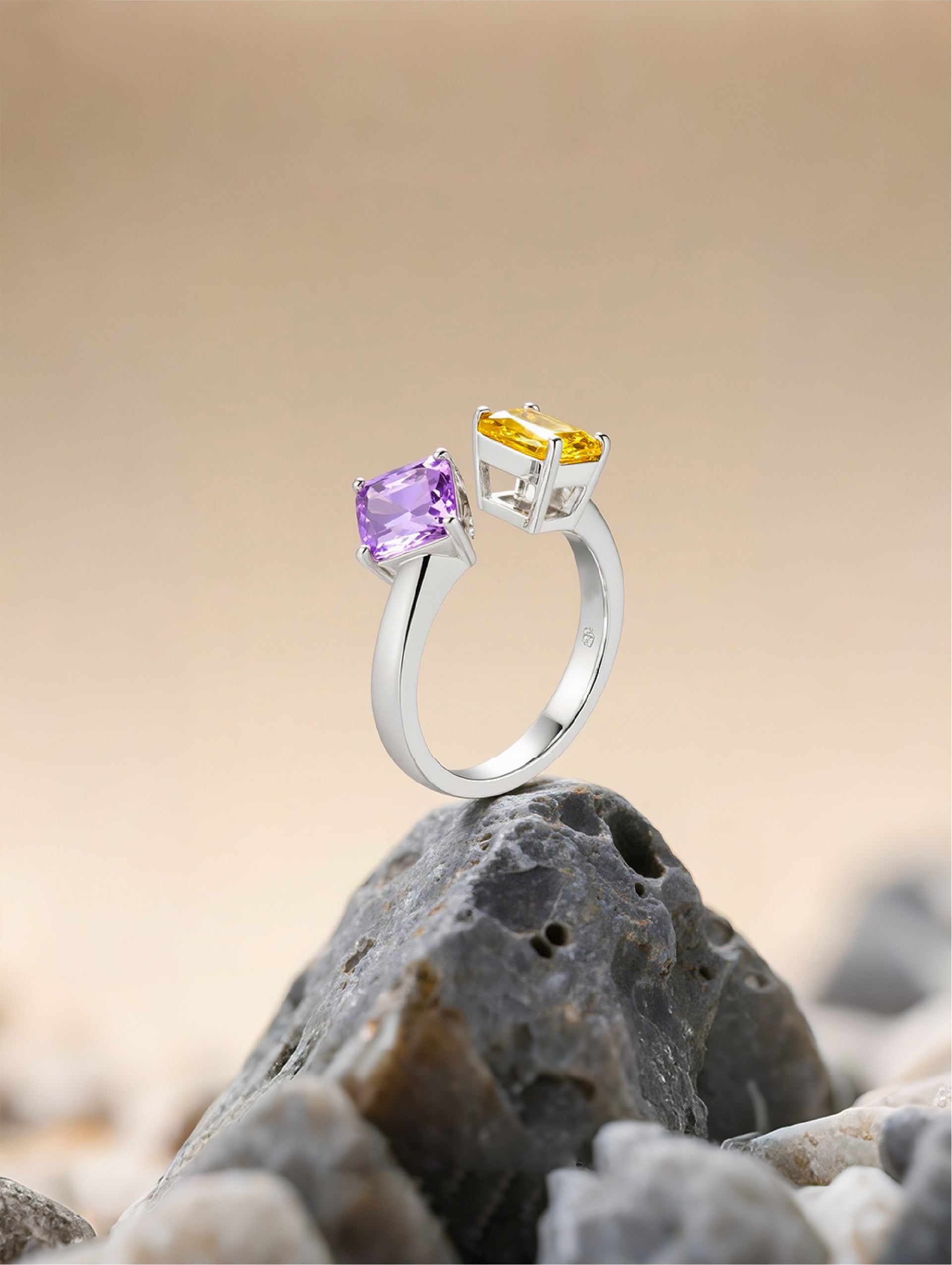 Own Your Bloom Colorful Gemstone Ring displayed on sand and rocks, representing color contrast and balance, Dallas.