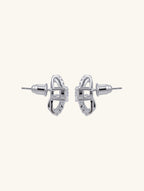 Own Your Bloom Crystal Ribbon Earrings top view featuring double arc silver bands and premium zircon sparkle, Chicago.