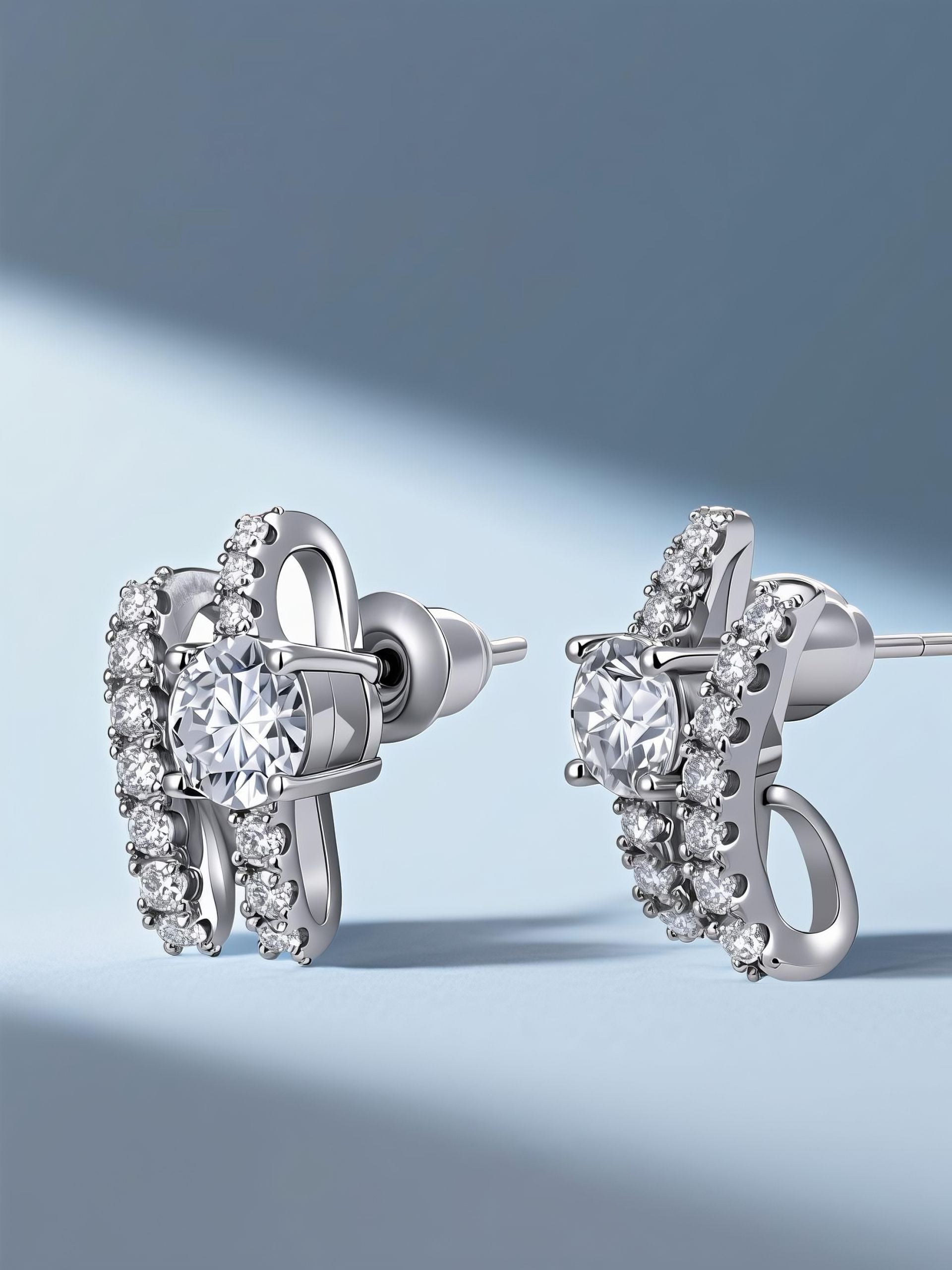 Own Your Bloom Crystal Ribbon Stud Earrings displayed under soft blue light, embodying elegance and modern rhythm, Miami.