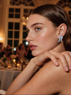 Own Your Bloom Crystal Ribbon Stud Earrings worn by woman at elegant evening event, exuding luxury sophistication, New York.
