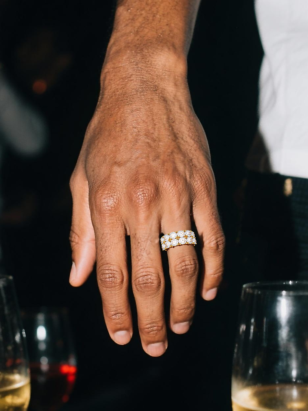 Close-up of Own Your Bloom double-row round eternity band on hand, continuous sparkle design.