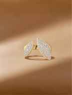 Own Your Bloom Dual Flame moissanite ring displayed on warm golden surface, symbolizing elegance and empowerment, Miami.