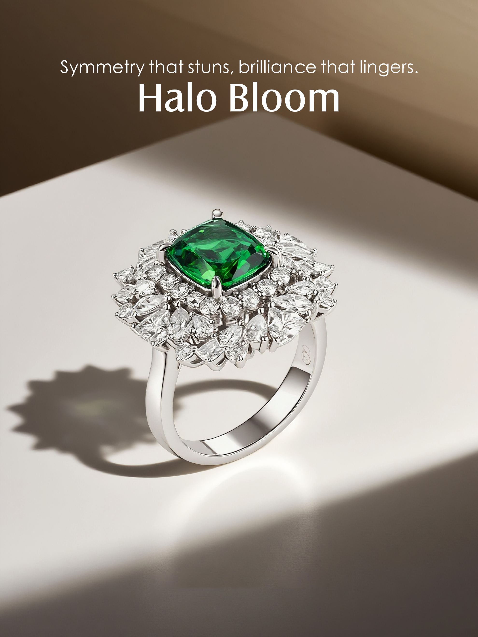 Own Your Bloom emerald and diamond halo ring in soft light with elegant shadow detail, Dallas.