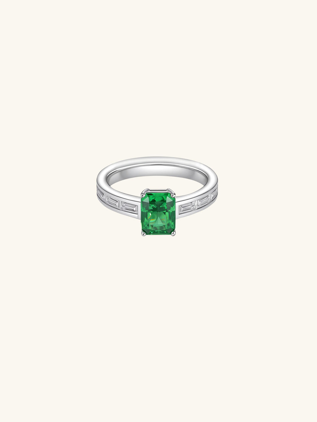 Own Your Bloom emerald cut diamond ring side angle showcasing rectangular baguette diamonds and green center stone, Los Angeles.