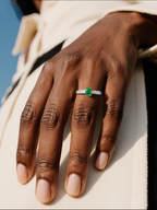 Own Your Bloom emerald baguette side ring worn by woman with sophisticated casual outfit, luxury accessory, Chicago.