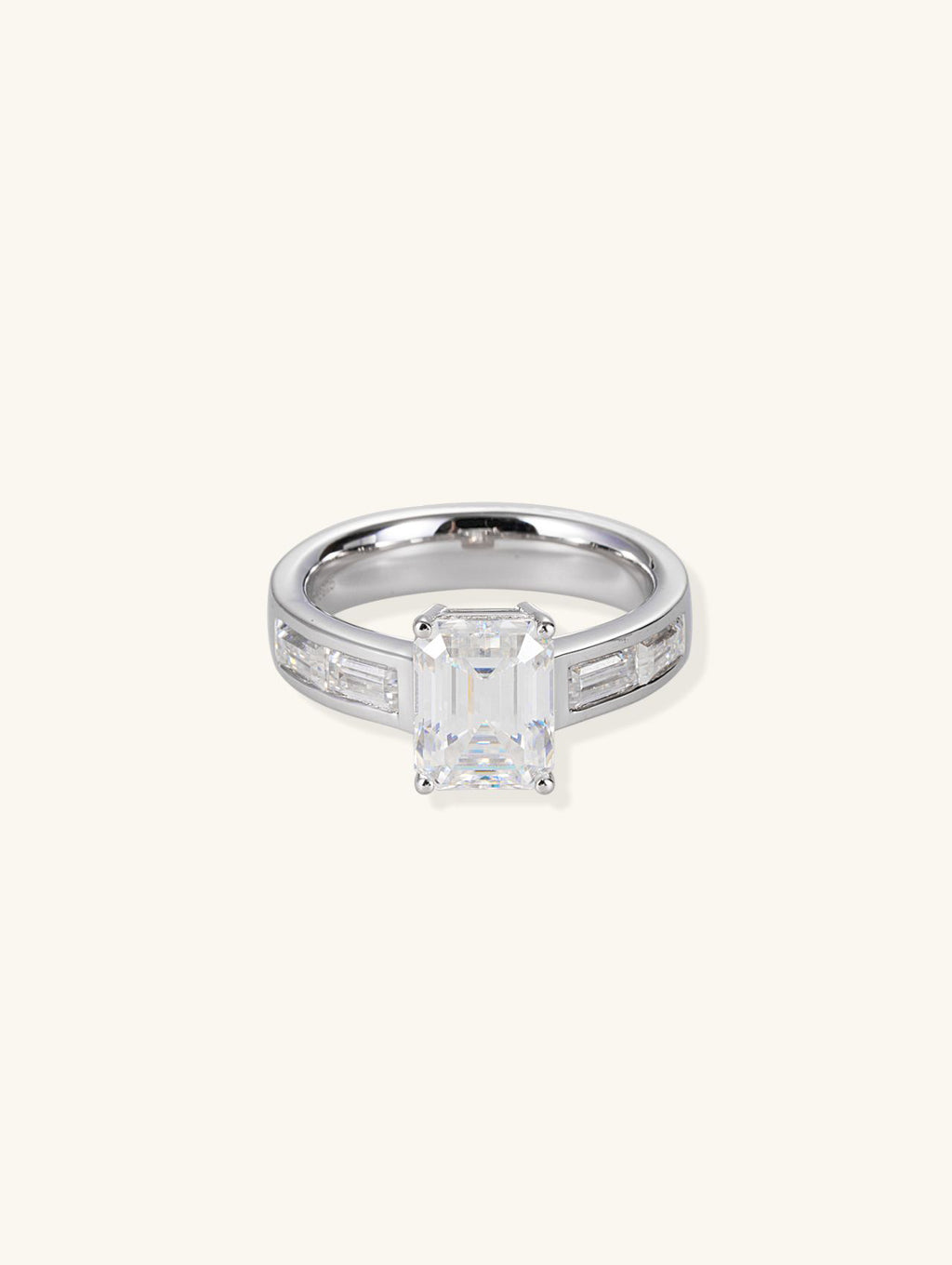 Own Your Bloom emerald-cut diamond engagement ring with baguette side stones, front view on white background, New York.