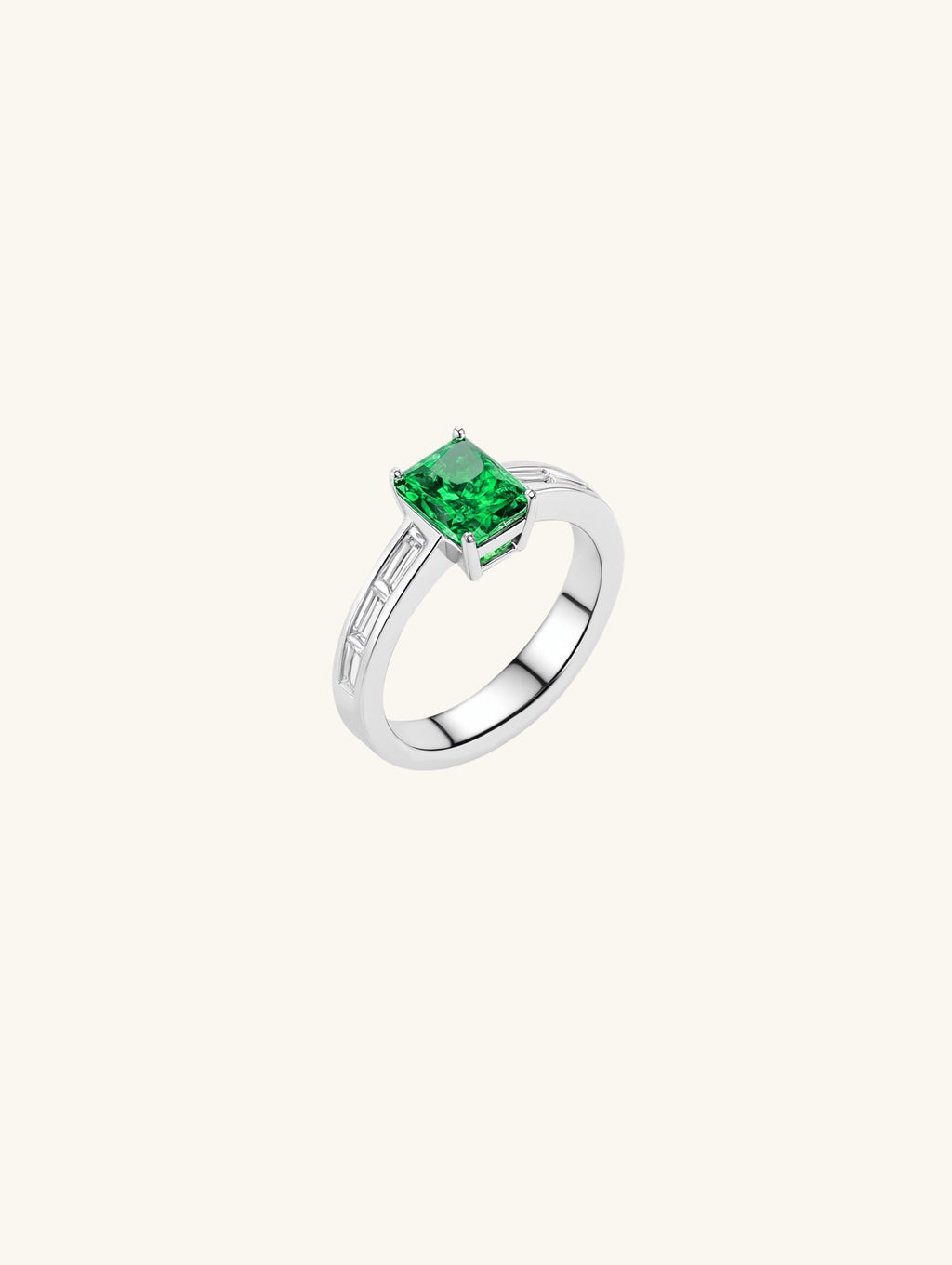 Own Your Bloom emerald cut baguette side ring front view with vivid green gemstone and white gold band, New York.