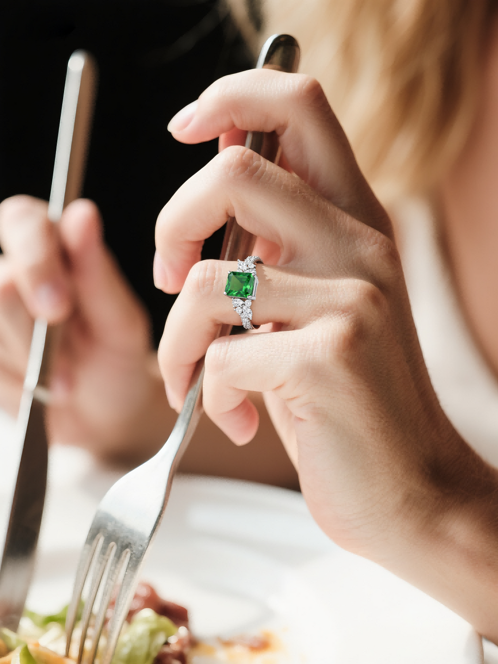 Own Your Bloom emerald cut green diamond ring on woman’s hand while dining, modern luxury jewelry look, Los Angeles.