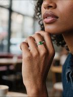 Own Your Bloom emerald cut baguette side ring worn by woman outdoors, radiant green gemstone jewelry style, Los Angeles.