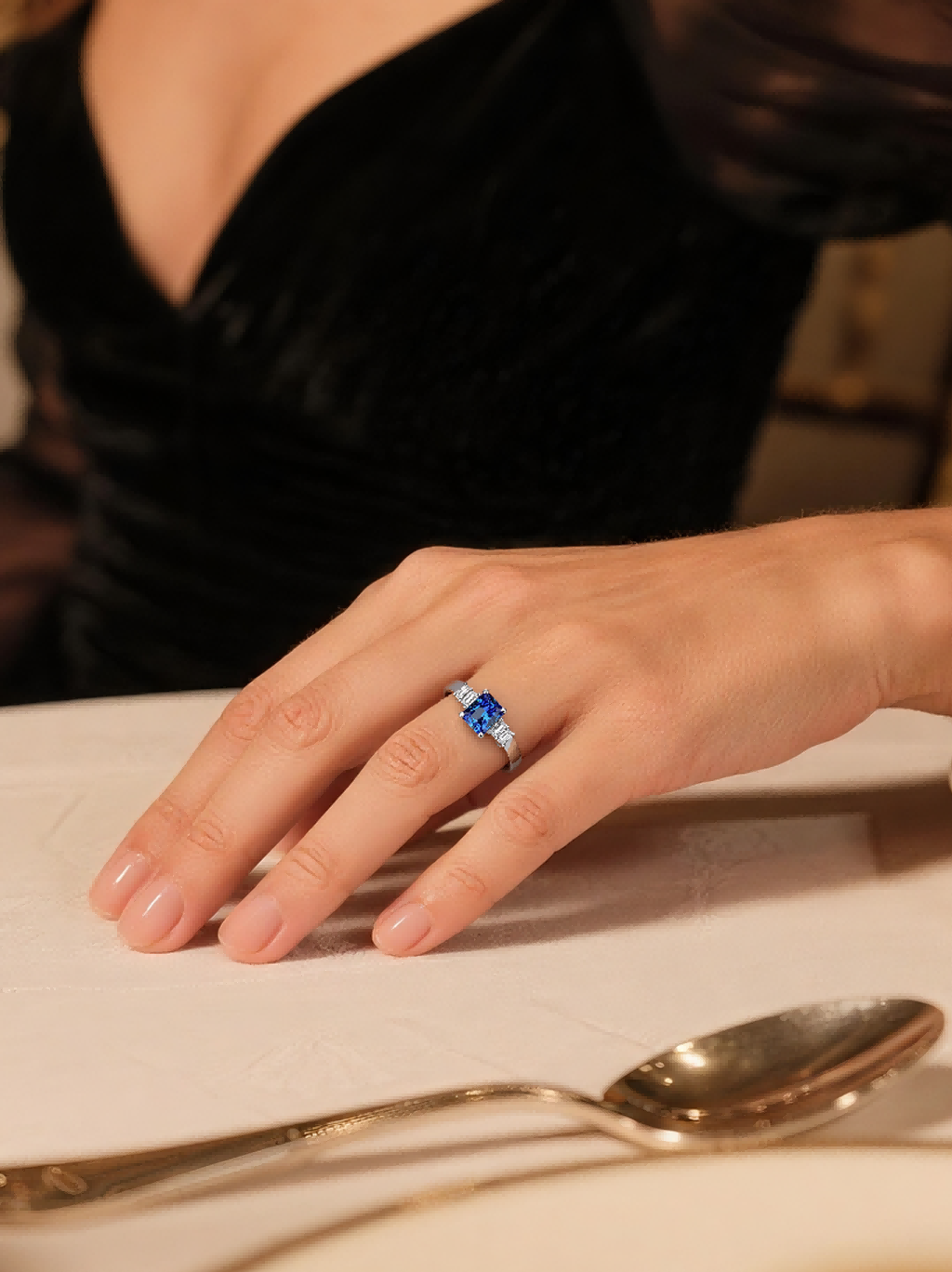 Own Your Bloom Emerald Cut Sapphire Diamond Ring worn by woman in warm light, symbolizing grace and confidence, Miami.