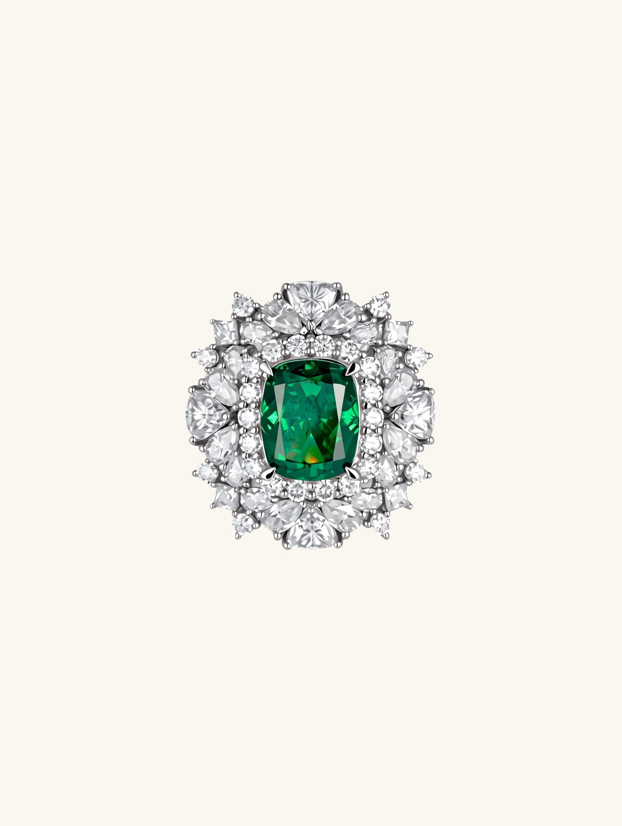 Own Your Bloom emerald diamond halo ring front view with oval green gemstone surrounded by brilliant-cut diamonds, New York.