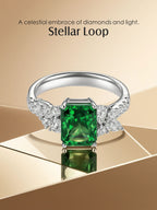 Own Your Bloom emerald green diamond ring on luxurious geometric backdrop under warm light reflection, Dallas.