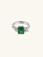 Own Your Bloom emerald cut green gemstone cluster ring front view with diamond accents and white gold band, New York.