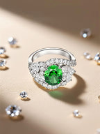 Own Your Bloom emerald oval halo diamond ring displayed in studio light emphasizing gemstone brilliance, Miami.