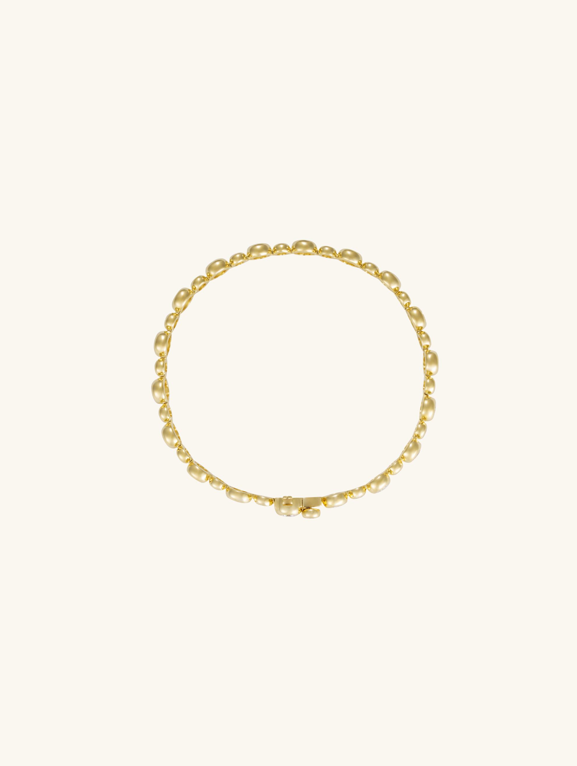 Own Your Bloom 18k gold bezel diamond tennis bracelet side angle highlighting brilliant diamond symmetry and timeless design, Los Angeles.