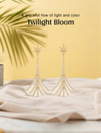 Own Your Bloom Twilight Bloom gold drop earrings displayed on soft beige fabric under warm sunlight, elegant minimalism, Miami.