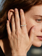 Own Your Bloom marquise and round moissanite ring worn by woman in natural sunlight, elegant fine jewelry for modern style, New York.