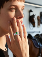 Own Your Bloom green cushion double band ring worn by woman indoors with natural light, modern jewelry fashion, Los Angeles.