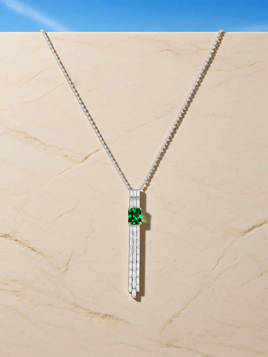 Own Your Bloom green gemstone tassel necklace showcased against architectural lighting emphasizing balance and brilliance, Dallas.