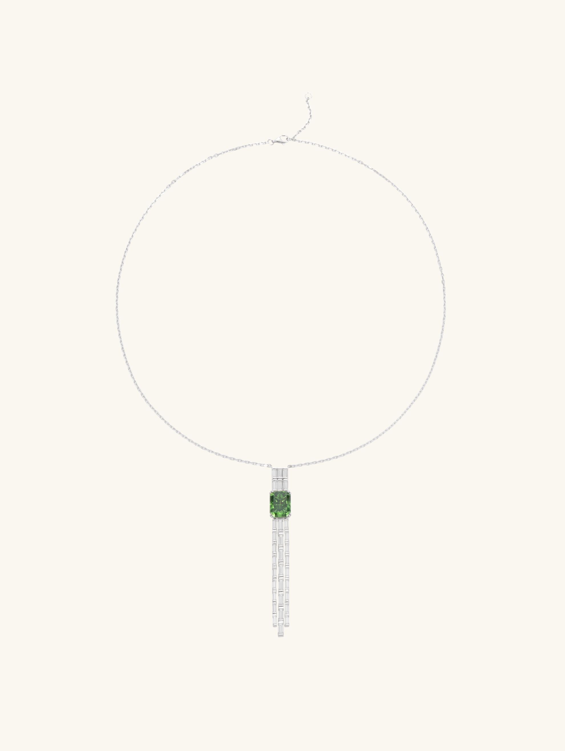 Own Your Bloom green gemstone tassel necklace side view highlighting baguette-cut diamond strands and radiant green gem centerpiece, Los Angeles.