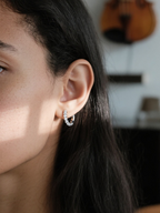 Own Your Bloom moissanite half hoop earrings worn by woman in natural light, minimal and radiant jewelry for everyday elegance, New York.