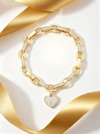 Own Your Bloom Rose Gold Heart Charm Bracelet displayed with golden ribbon, symbolizing luxury and feminine elegance, Miami.