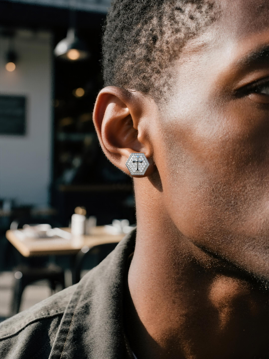 Own Your Bloom 14K cross diamond stud earrings worn by woman beside motorcycle, edgy luxury fashion aesthetic, Miami.