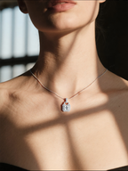Own Your Bloom 14K gemstone pendant worn by woman, close-up neckline in natural light, Boston.