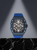 Own Your Bloom men’s mechanical watch displayed on marble pedestal under spotlight, lifestyle composition, Seattle.