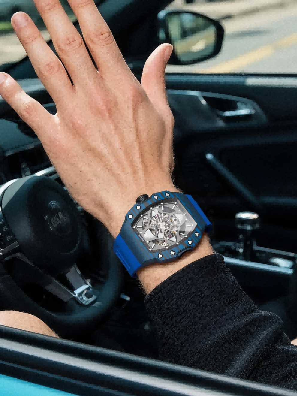 Own Your Bloom men’s mechanical watch with blue strap on wrist, man in streetwear, city street scene, Boston.